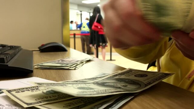 Woman counting US dollar inside HSBC bank with 4k resolution