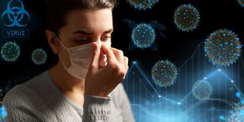 health protection, safety and pandemic concept - sick young woman adjusting protective medical face mask over coronavirus virions on black background