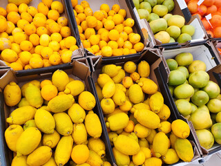 A lot of citrus fruits on market counter. Top view