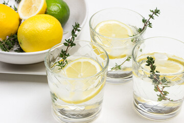 Lemon drink in glass. Thyme sprigs in glass