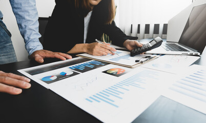 A group of professional business people sit on a meeting table in the office to discuss banking issues. Share partner A meeting idea that talks about a graph