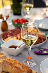 Set up table with white wine and appetizers