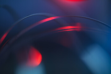 futuristic blurry abstract background in blue and red cinematic tones. strings, strips of arcs and with light highlights.