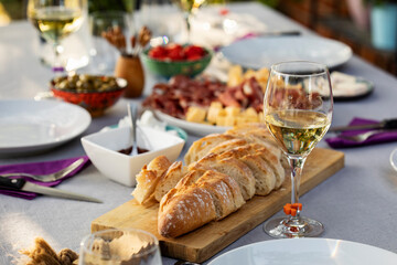 Set up table with white wine and appetizers