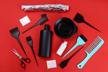 Tools for hair dye, for the hairdresser, topview on red background
