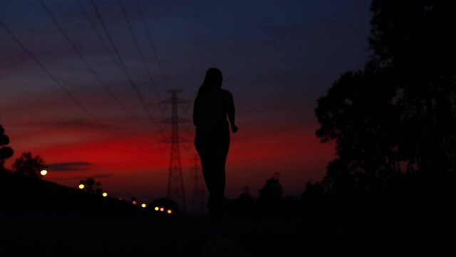silhouette woman running slow motion