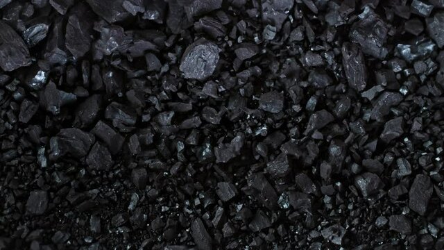 Super Slow Motion Shot of Crushing Coal on Black Background at 1000 fps.