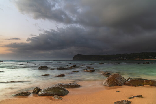 Sunrise at the seaside with rain clouds rolling in