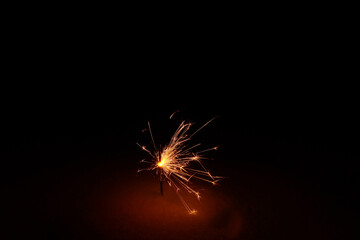 sparklers, bengal fire burns in a snowdrift at night