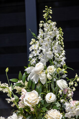 Impressive floristic bouquet of white roses and delphinium - green twist