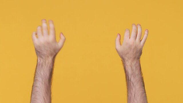 Cropped close up man male hands touch something like push click on button pointing at floating virtual screen typing on vr keyboard gesture isolated on yellow background studio Copy space mock up area