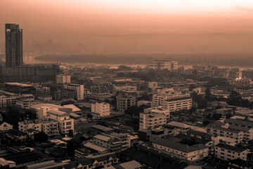 Fototapeta premium The high angle background of the city view with the secret light of the evening, blurring of night lights, showing the distribution of condominiums, dense homes in the capital community