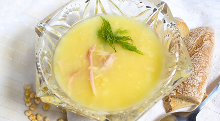 Pea soup with meat, decorated with dill, which is poured into a crystal vase. The creative flow.