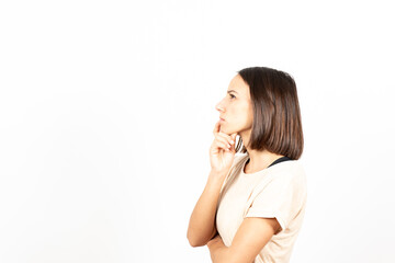 Fototapeta premium A brunette hispanic woman thinking on an idea with serious gesture and looking to copy space.