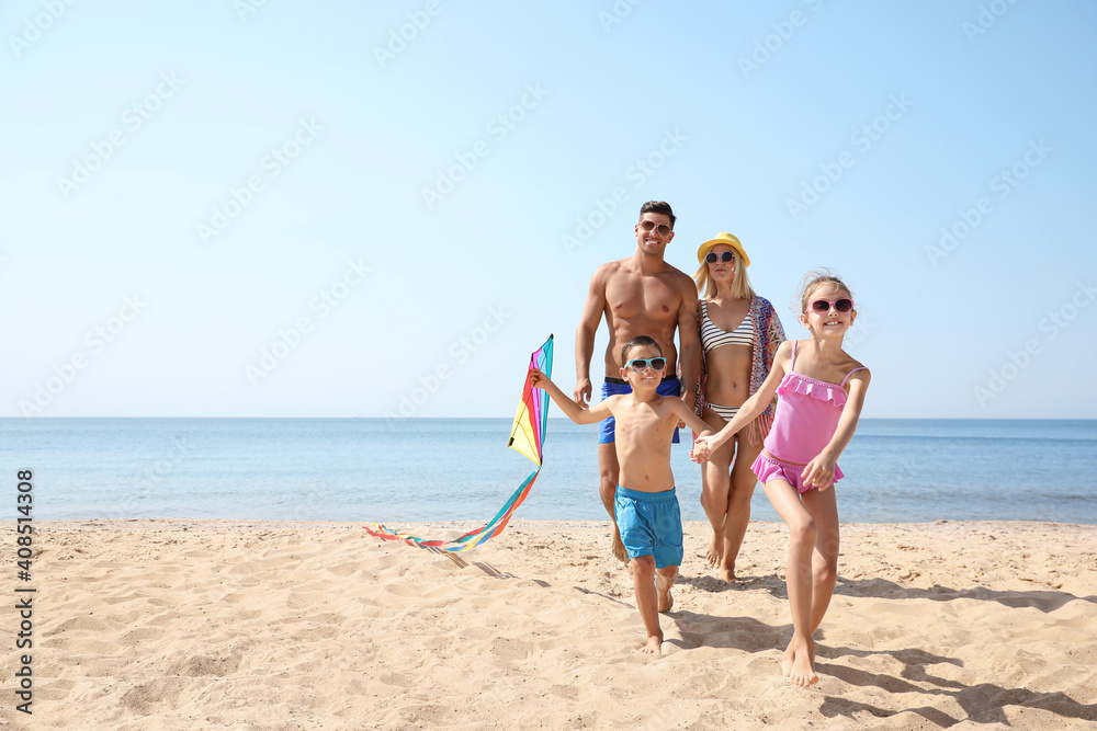 Poster happy family with kite at beach on sunny day