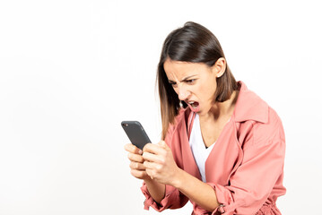 Naklejka premium Angry latin woman looking at her cell phone.