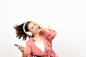 Fototapeta premium Happy latin woman with headphones dancing and looking to white copy space.