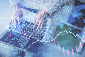 Multi exposure of woman hands working on computer and forex chart hologram drawing. Top View. Financial analysis concept.