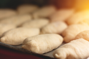 Grandma's apple pies on a baking sheet, before baking, sweet buns