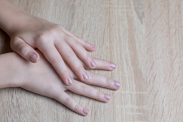 Children's hands with dirty nails on the table.