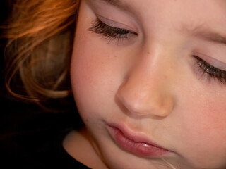 Fototapeta premium Close-up of a preschool girl using a mobile phone