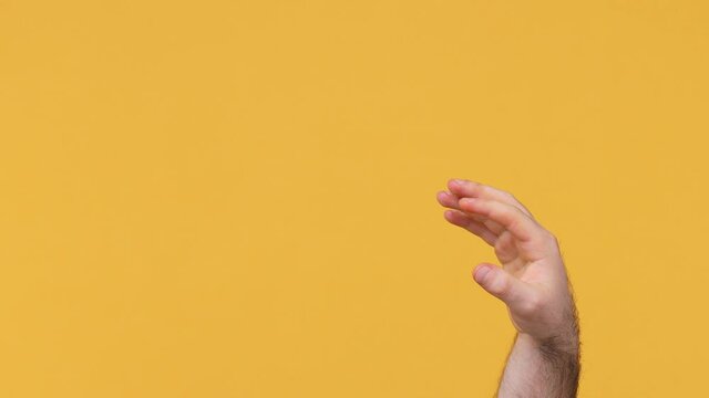 Cropped close up man male hand snap finger banishing scat go about your business away gesture isolated on yellow background studio Copyspace commercial promo advertisement Advertising workspace mockup