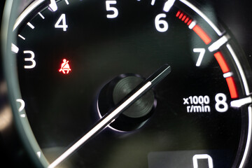 A dashboard with tachometer of car, close up.