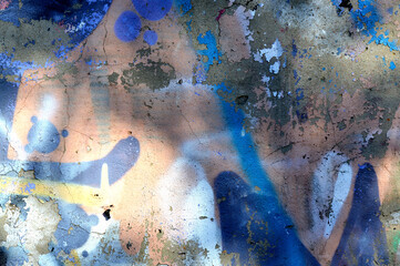 Abstract photo background. Old graffiti paint on the wall. Fragment with scratches and cracks. Beige, brown, blue, white, orange and grey colors. Abstract concrete background grunge texture