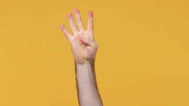 Cropped close up man male hand showing fingers ordinal count from one to five 1 5 gesture isolated on yellow background studio. Copy space commercial promo advertisement. Advertising workspace mock up