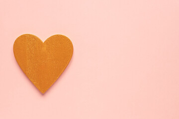 Valentine's day concept with golden wooden heart on light background, top view, copy space.