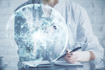 Double exposure of business theme sketch hologram and woman holding and using a mobile device.