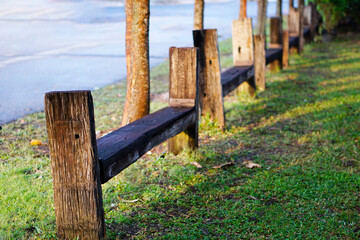 Close up natural wooden bench build as seat fence in park.   
