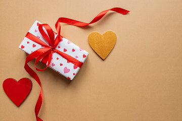 Festive St Valentne's day concept with gift box on beige background. Top view, copy space