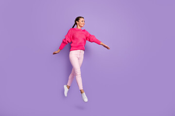Fototapeta na wymiar Full size profile side photo of young beautiful attractive smiling cheerful girl jumping go walk isolated on violet color background