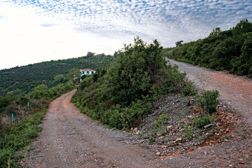 A cross road in on a hill, lovely clouds above