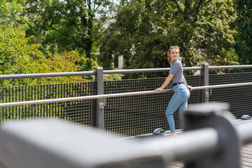 young woman standing on small bridge and looking back