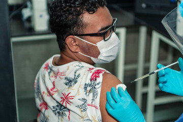 Man receiving his vaccine. Antivirus vaccination for people.