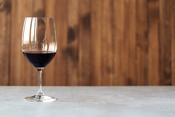 Horizontal side view on a glass of red wine on the table