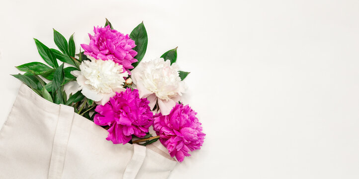 Cotton eco bag with peony flowers on white background Zero waste concept. Flat lay. Top view - Image