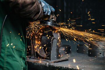 Angle grinder at work, yellow tracks from sparks flying away in the process. Closeup image