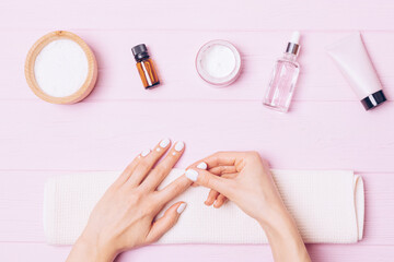 Obraz na płótnie Canvas Home nail care, female hands apply nourishing cuticle cream
