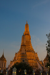 Illuminated Wat Arun Temple in sunset. Buddhist temple in Bangkok, Thailand. Vertical orientation 