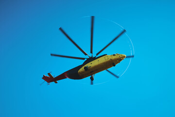 The world's largest cargo helicopter hovers overhead. Bottom view.