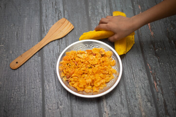 Boli with Corn Flakes in a steel bowl 