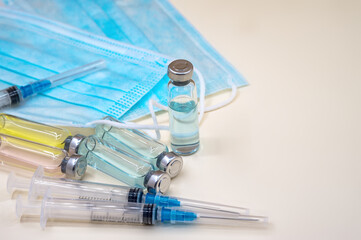 Vaccination covid-19. Syringe and drug vials. Immunization and treatment of infection.