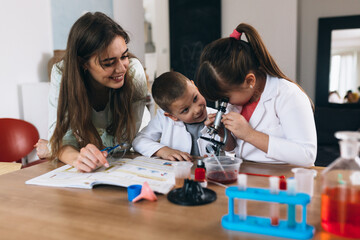 children with their mother do chemical experiments from kitchen ingredients at home