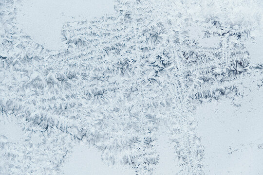 Ice patterns on frozen glass. Abstract ice pattern on winter glass as a background image. Copy, empty space for text