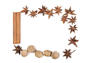 Fototapeta na wymiar Cinnamon stick with anise stars and nutmeg pile frame and border isolated on white background, top view