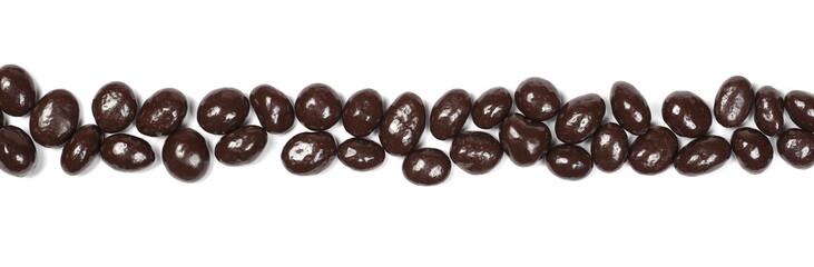 Chocolate coated raisins row pile isolated on white background