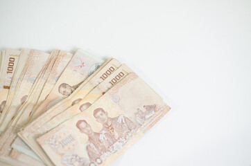 A thousand baht banknote on a white background
